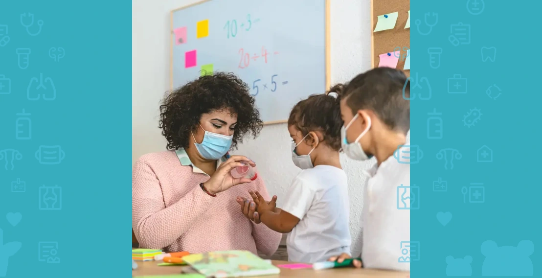 The teacher disinfects the student's hands